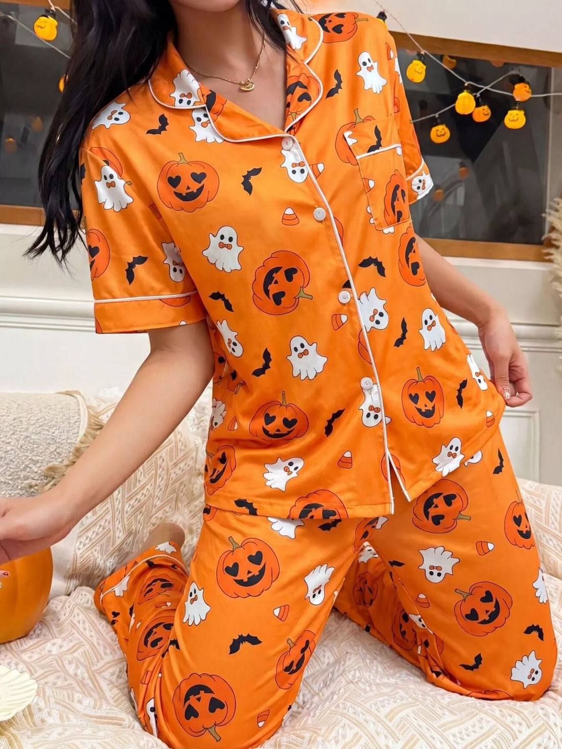Halloween pajama set: orange short-sleeve button-up shirt with pocket and halloween character prints