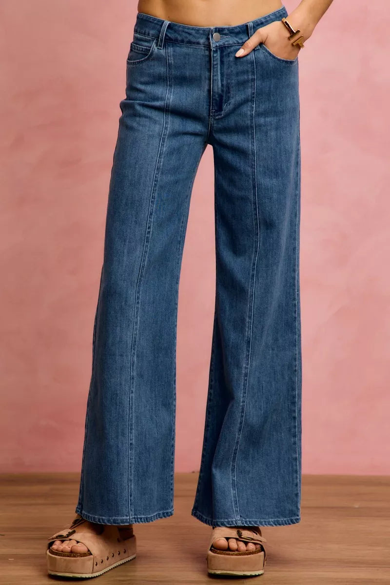 Mid-rise stretch denim jeans, front view with straight waistband and flared legs