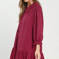 Mulberry mini dress side view with smocked ruffle V-neck, tiered hem, puff sleeves