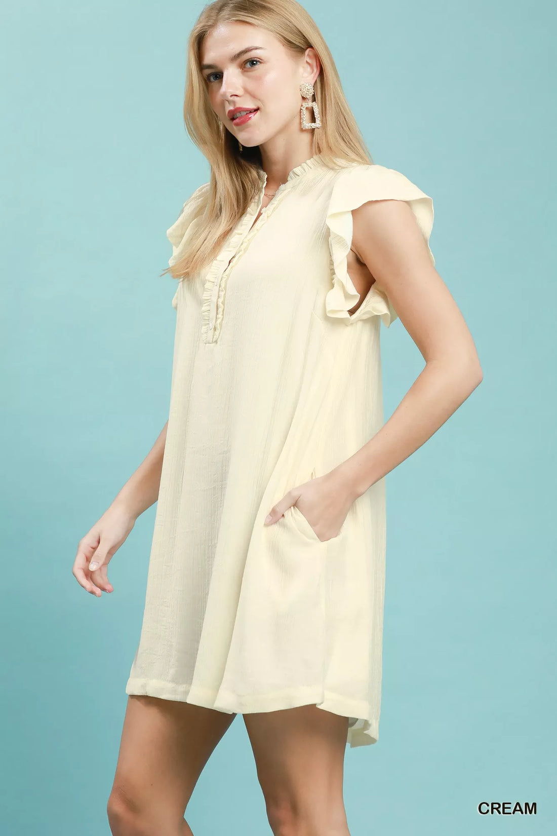 Cream ruffle-sleeve henley shift dress, short length, partial side view