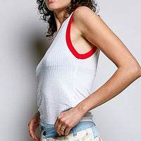 Off-white ribbed sleeveless tank with red contrast V-neck trim and armholes