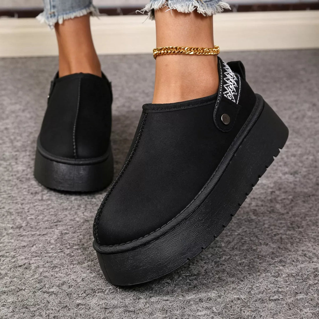 Black suede fur-lined platform boots with side panel seam and chunky tread.