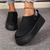 Black suede fur-lined platform boots with side panel seam and chunky tread.