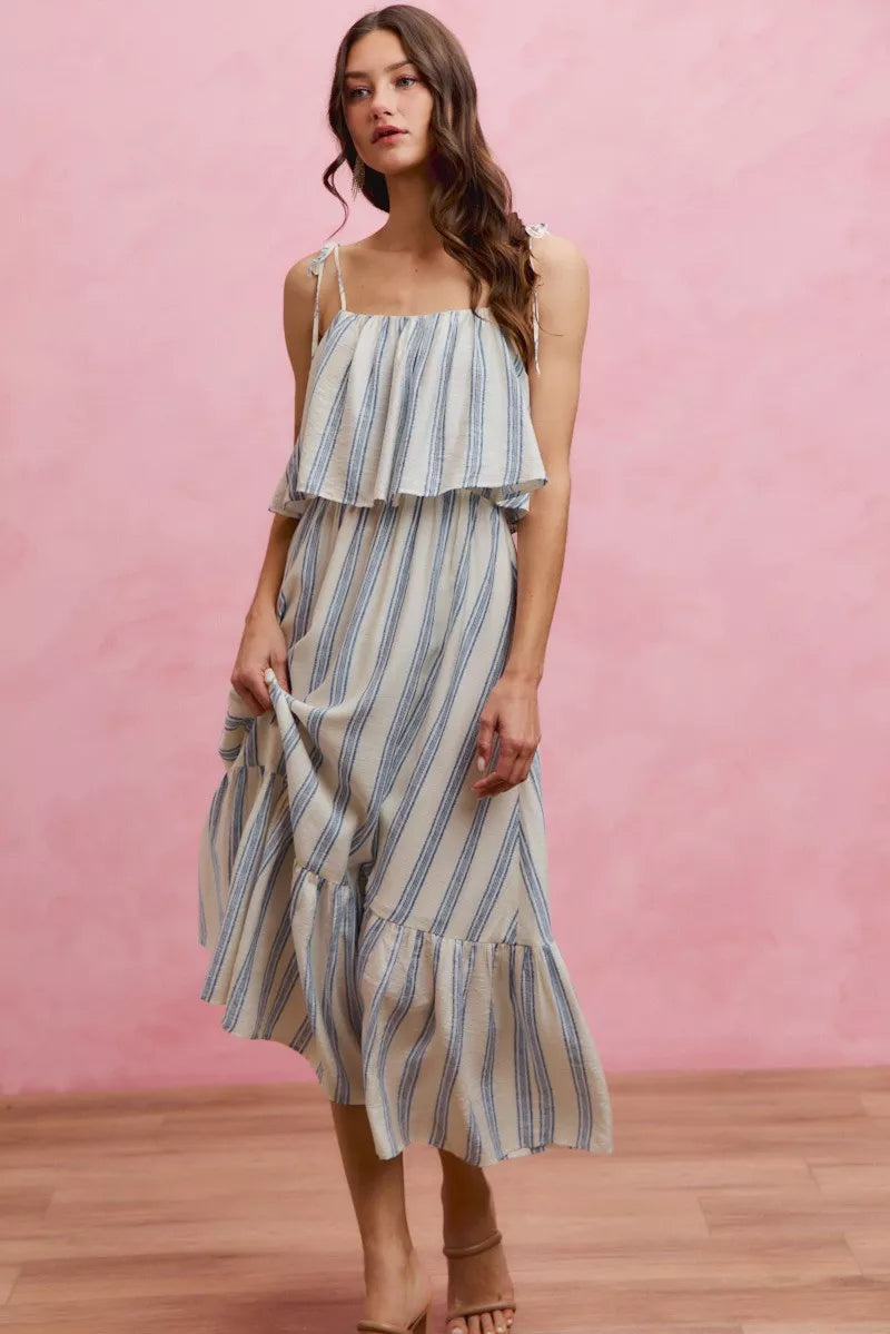 Sleeveless striped midi dress with tiered ruffle skirt and tie shoulder straps, blue and white
