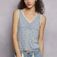 Powder blue ruched floral V-neck tank with lace trim along neckline