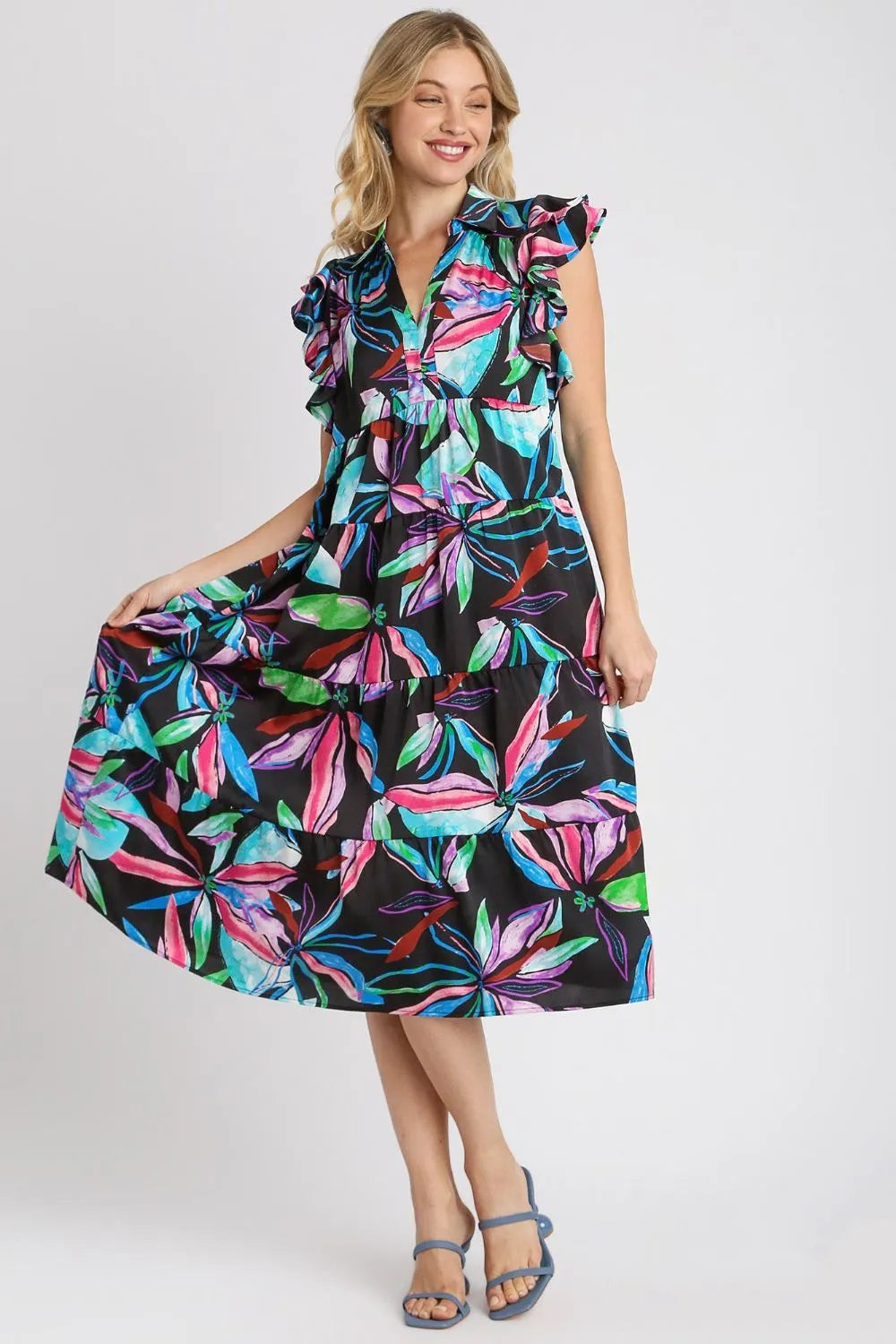 Plus size midi dress with black base and multicolor leaf print, ruffle sleeves.