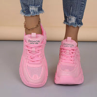 Pink chunky platform sneakers with lace-up front and thick cushioned platform sole.