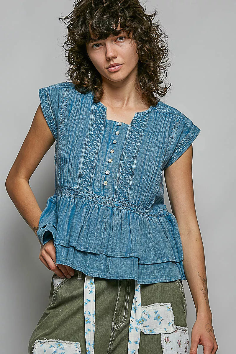Denim blue sleeveless eyelet-embroidered pintuck blouse with front buttons