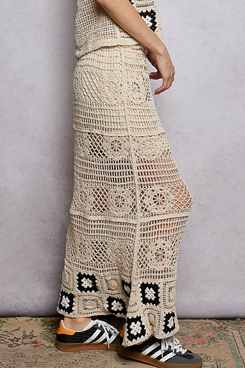 Natural crochet maxi skirt with ruffled waistband and black granny-square cuffs at hem