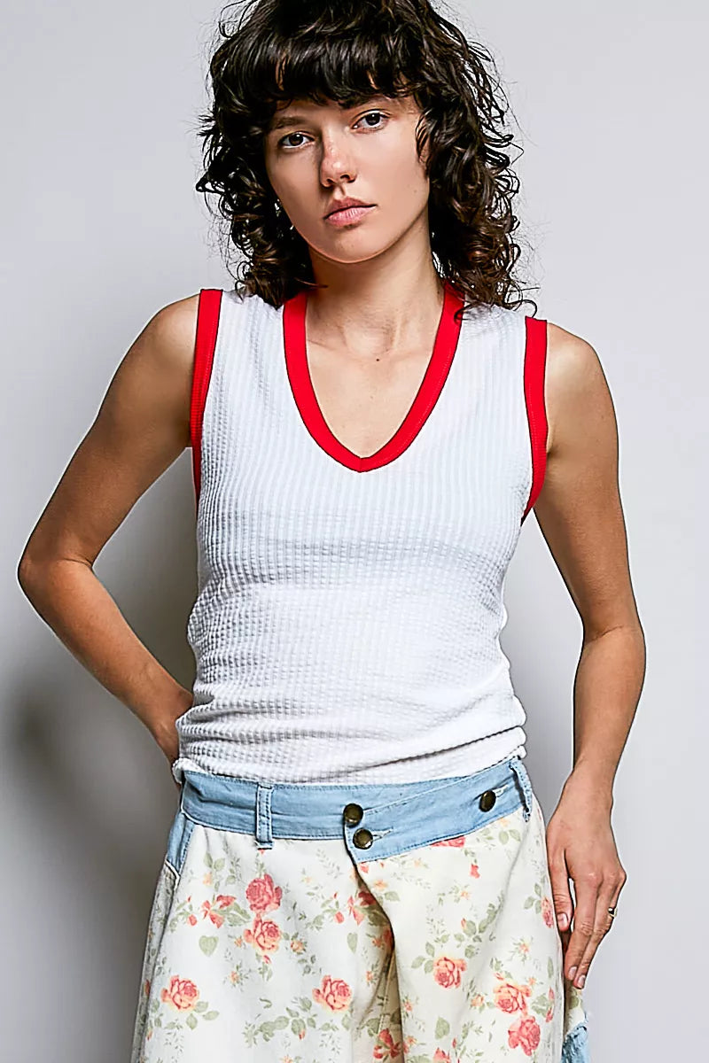 Off-white ribbed V-neck sleeveless tank with red contrast neckline and armholes
