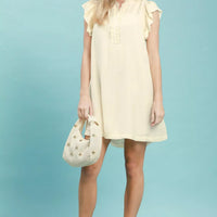 Cream ruffle-sleeve henley shift dress with ruffled shoulders and short hem