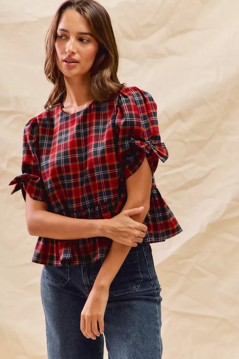 Red plaid peplum top with ribbon-tied short puff sleeves and peplum hem