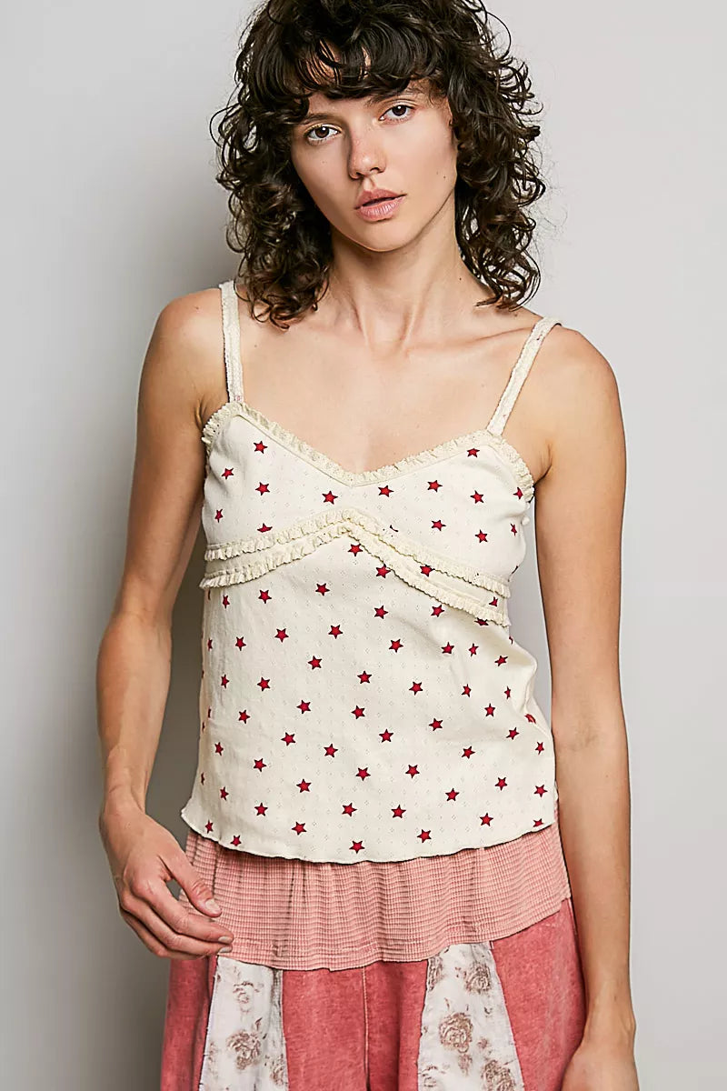 Ribbed knit cami with V-neckline, red star print on natural base, thin straps, draped hem