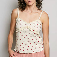 Ribbed knit cami with V-neckline, red star print on natural base, thin straps, draped hem