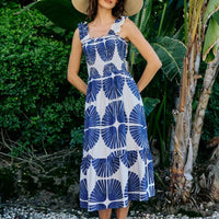Smocked bodice tiered midi dress with navy-and-white abstract print, sleeveless, lined