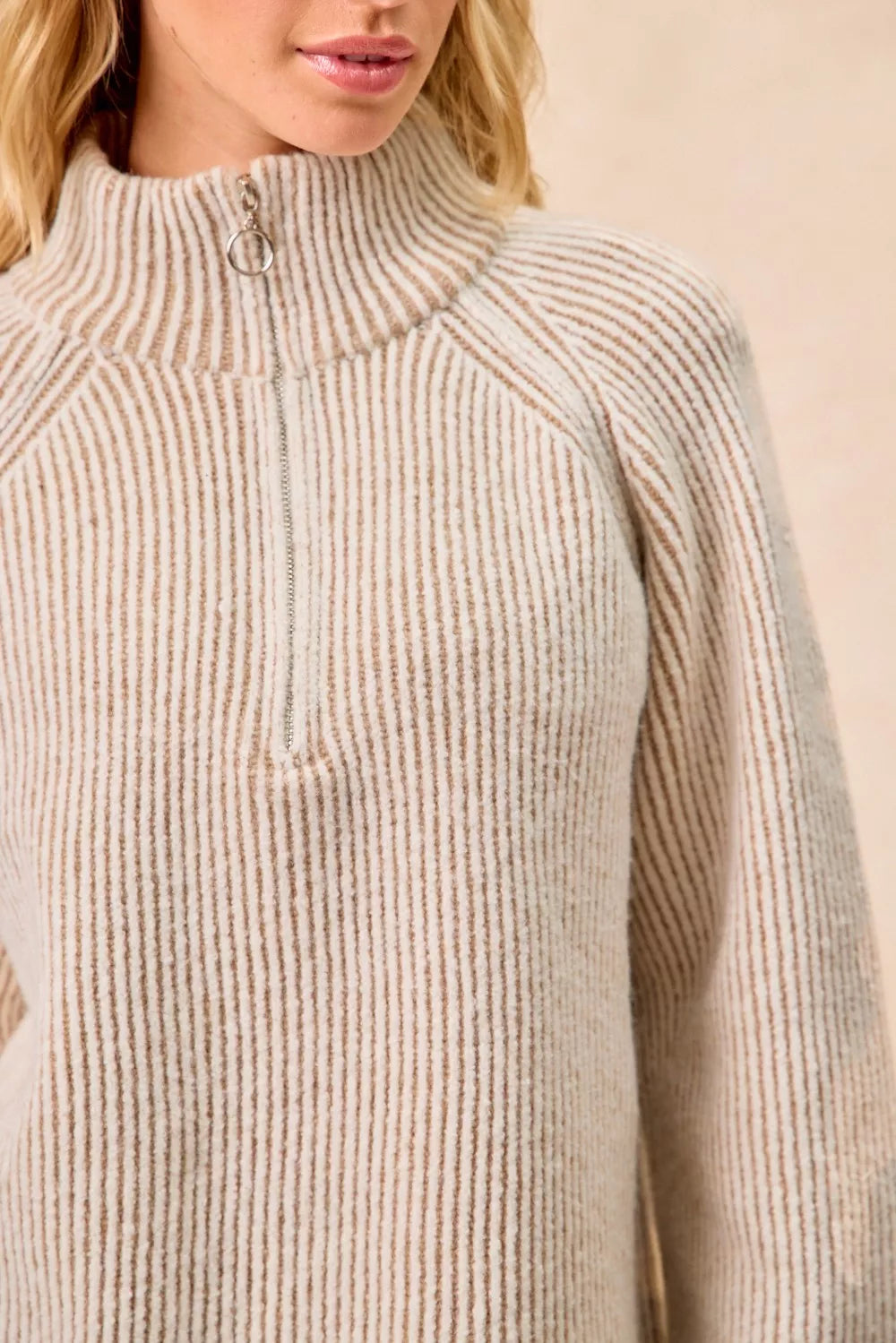 Taupe ribbed knit top with stand collar and quarter-zip placket, close-up