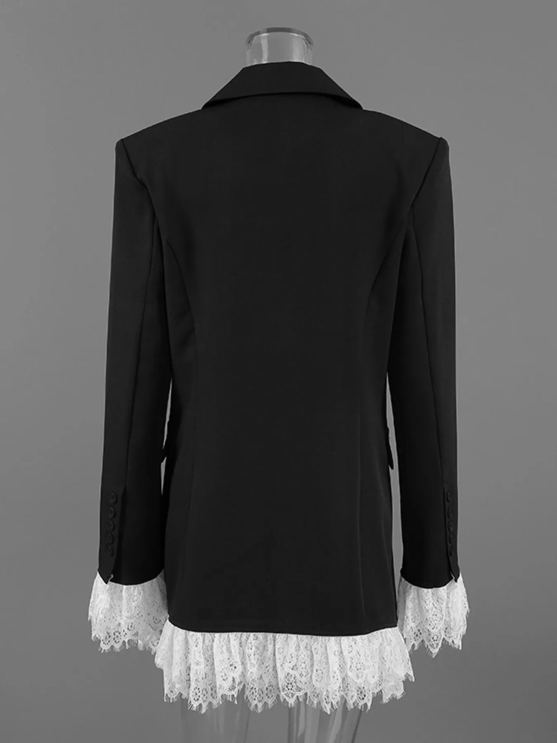 Back view of black blazer with lace-trim hem on a mannequin