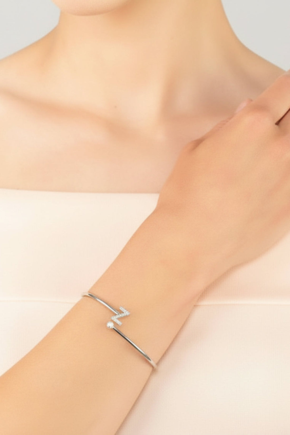 Silver initial Z bangle bracelet worn on wrist