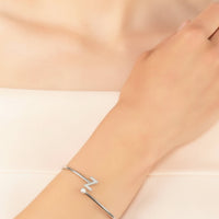 Silver initial Z bangle bracelet worn on wrist