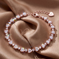 Heart tennis bracelet with oval stones and heart-shaped clasp charm