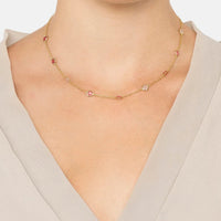 Gold bead charm necklace on model neck with pink and light blue accents