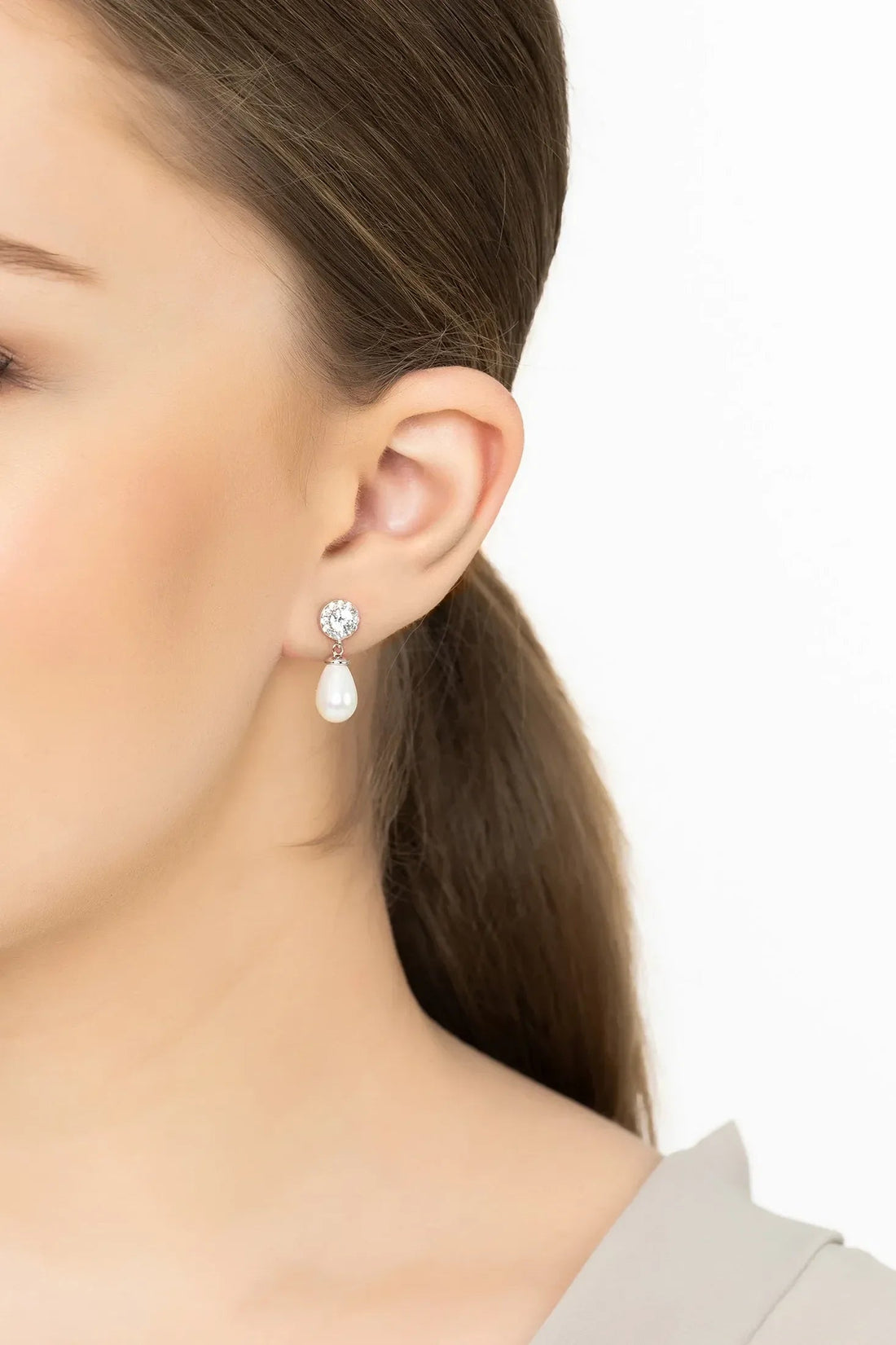 Silver earrings with round sparkle studs and teardrop white pearl drops