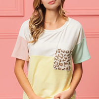 Color block crew neck top with leopard print front pocket, short sleeves, pale yellow base