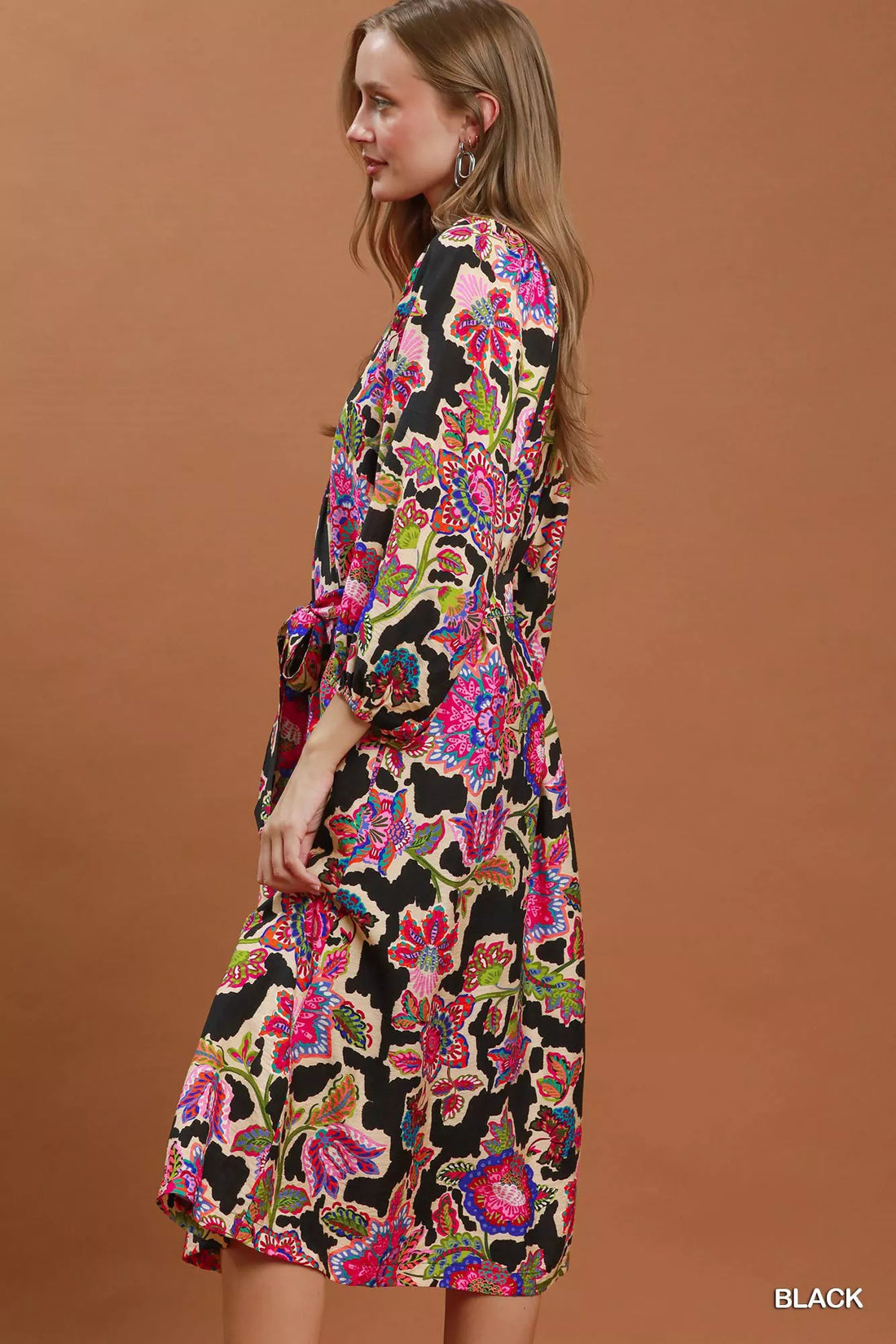 Black abstract print belted midi dress, side view, V-neck and long puff sleeves