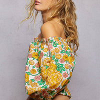Floral off-shoulder smocked blouse with long puff sleeves, side view