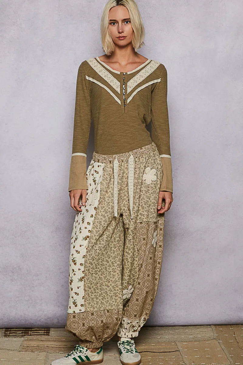 Olive ribbed knit top with white V trim, contrast cuffs, and half-button front