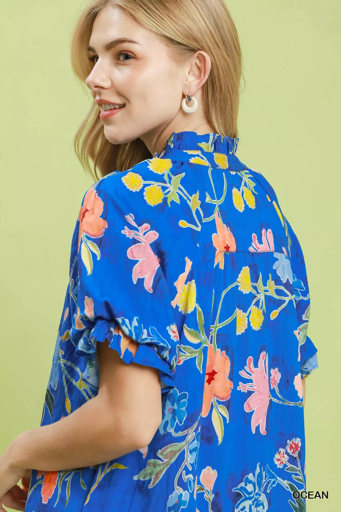 Blue floral mini dress close-up of ruffled neckline and puff sleeve