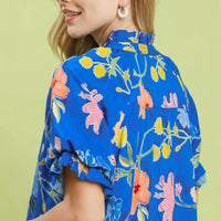 Blue floral mini dress close-up of ruffled neckline and puff sleeve
