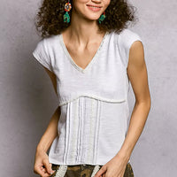 Off-white textured knit V-neck short-sleeve top with lace trim and gathered bust