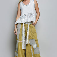 Off-white ribbed tank top with floral band and gathered ruffle hem