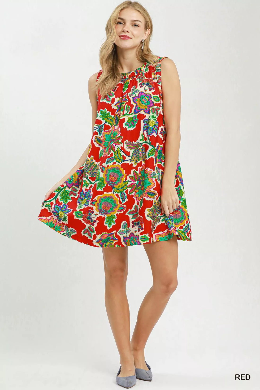 Red sleeveless shift dress with colorful abstract floral print and flared skirt