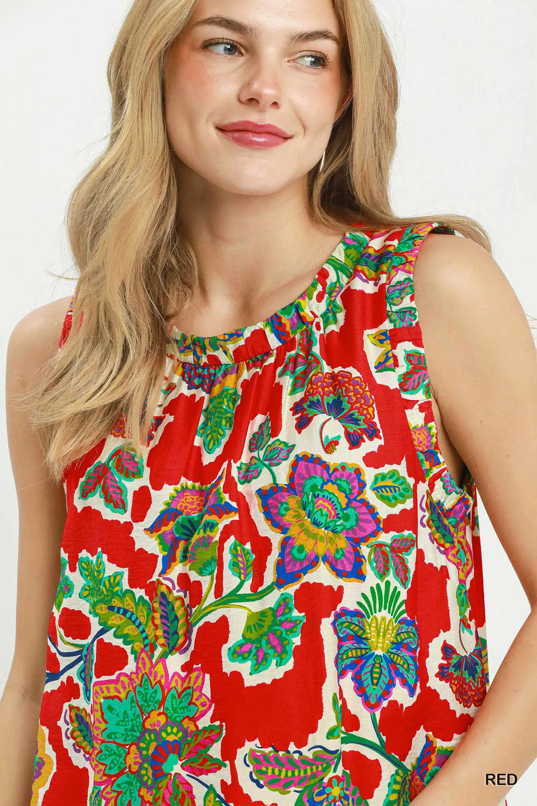 Close-up of red sleeveless shift dress with colorful abstract floral print