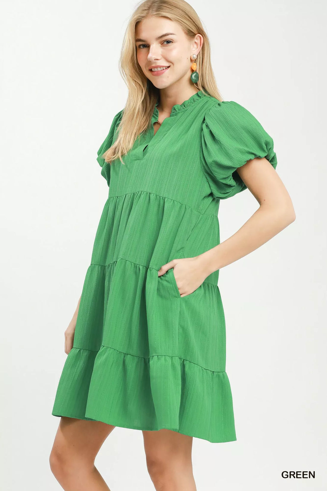 Green tiered babydoll dress with gathered bodice and puff sleeves