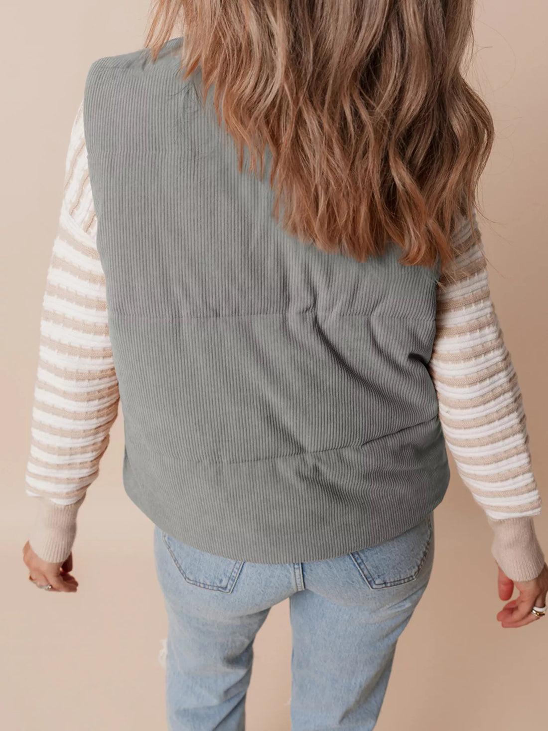 Gray corduroy stand-neck zipped puffer vest, back view with quilted channel stitching.