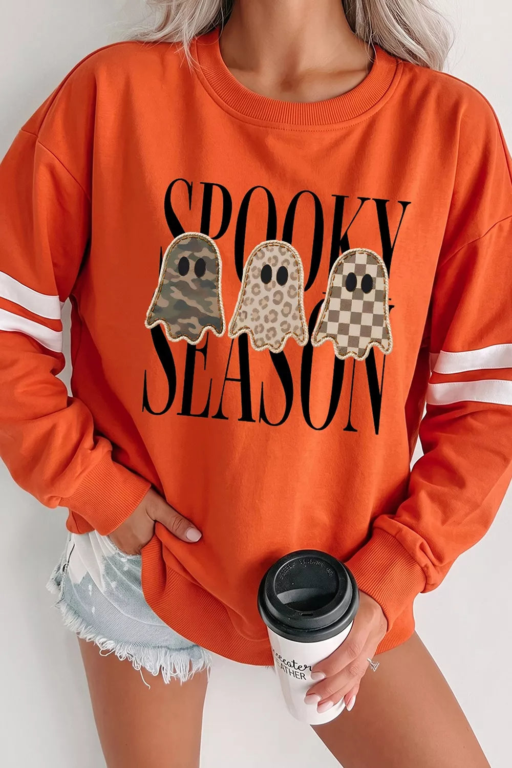 Orange crewneck pullover sweatshirt with spooky season ghost graphic