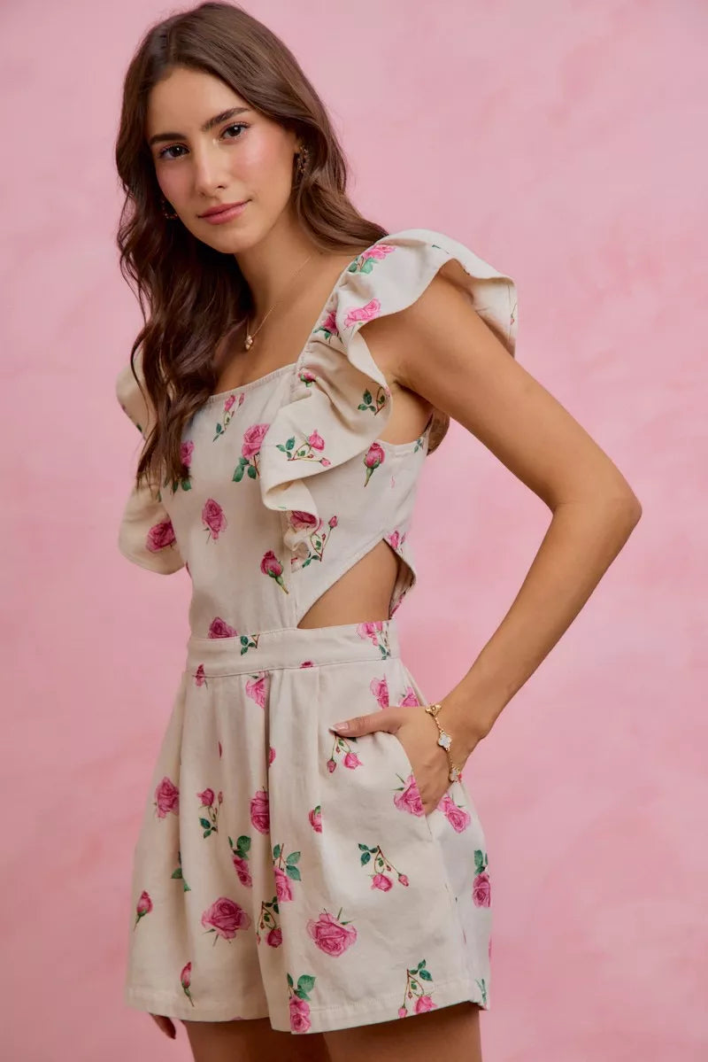 Ivory floral romper with cut-out waist and ruffled sleeves, pink rose print