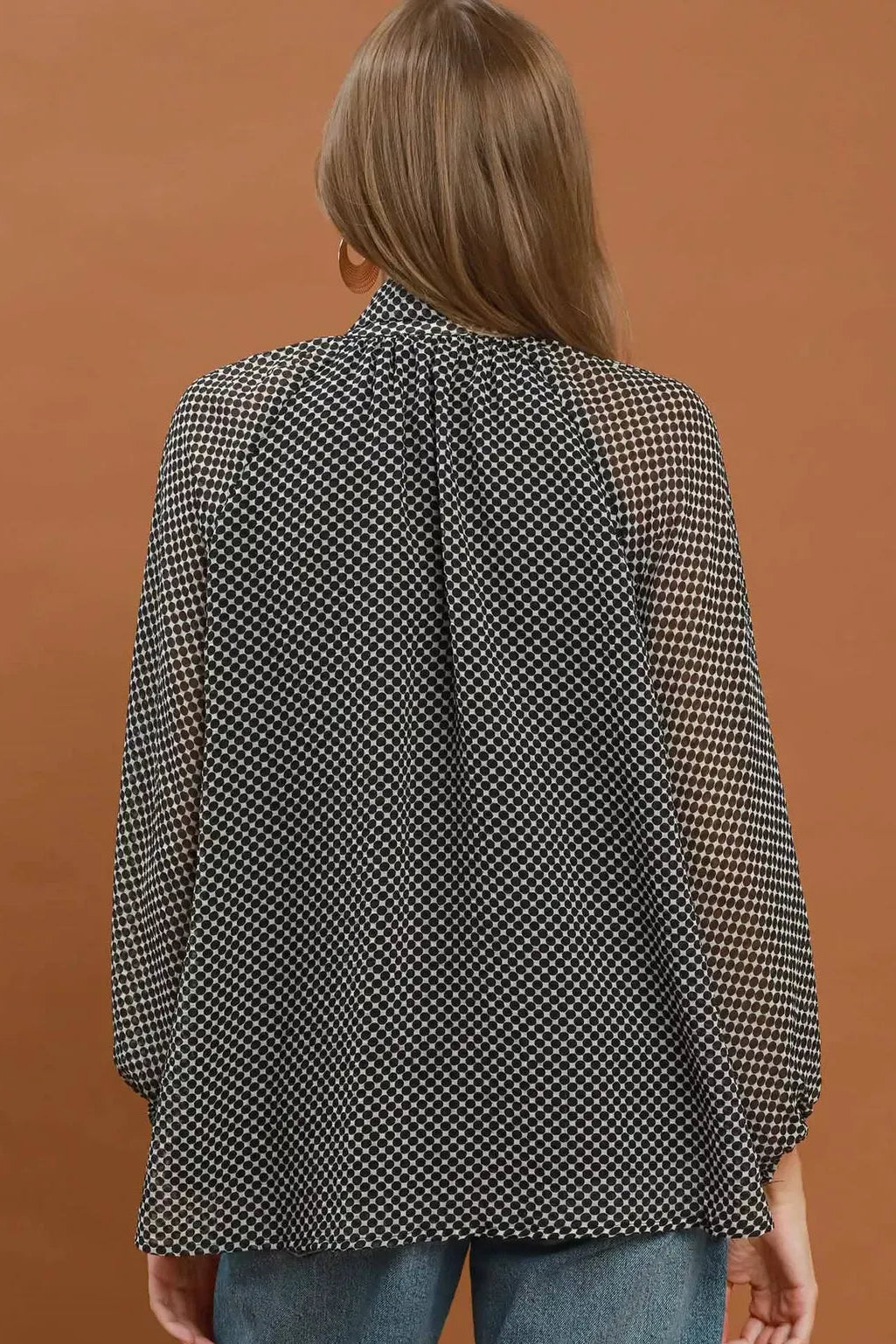Black and white dot print tie-neck blouse, full back view with long sleeves