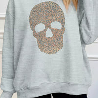 Gray mock-neck pullover sweatshirt with glitter skull graphic, front view