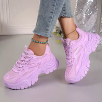 Purple chunky platform sneakers, lace-up with mesh uppers and thick platform sole.