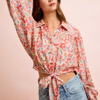 Floral print crop shirt with button front, puff sleeves, and tied hem knot