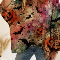 Plus size loose knit cover-up with multicolor Halloween graphics in pink, green, orange, and cream.