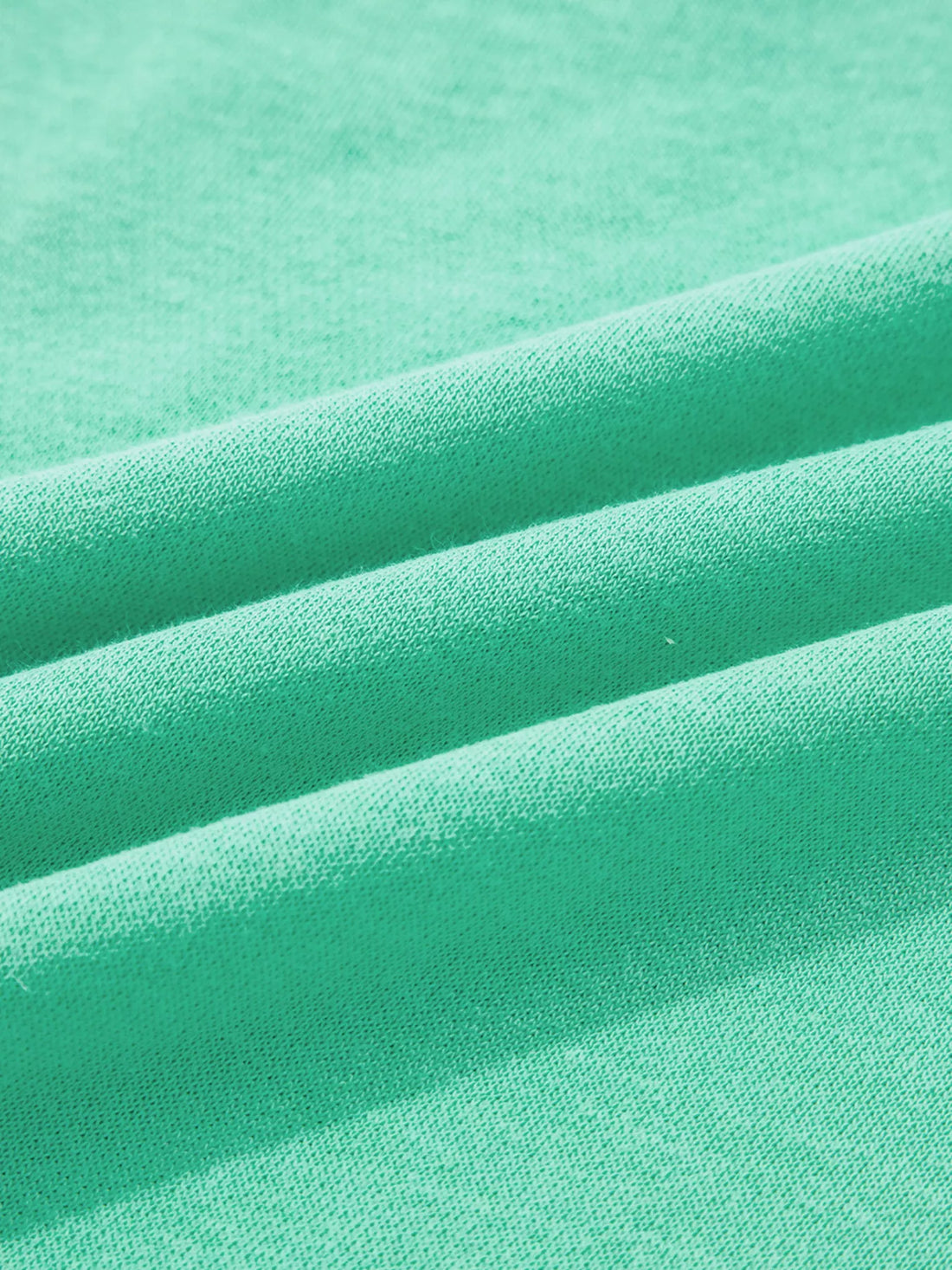 Turquoise sweatshirt fabric close-up showing soft knit texture