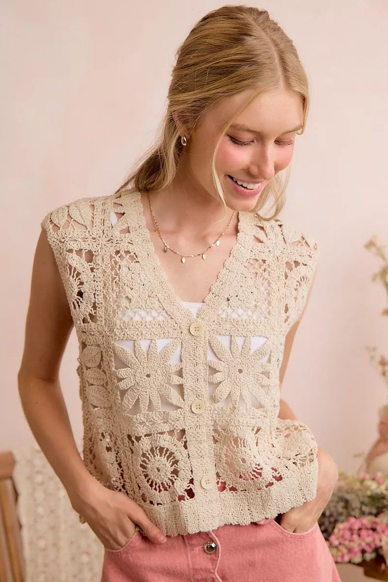 Natural crochet sleeveless vest with V-neck, front buttons, and textured granny-square motifs