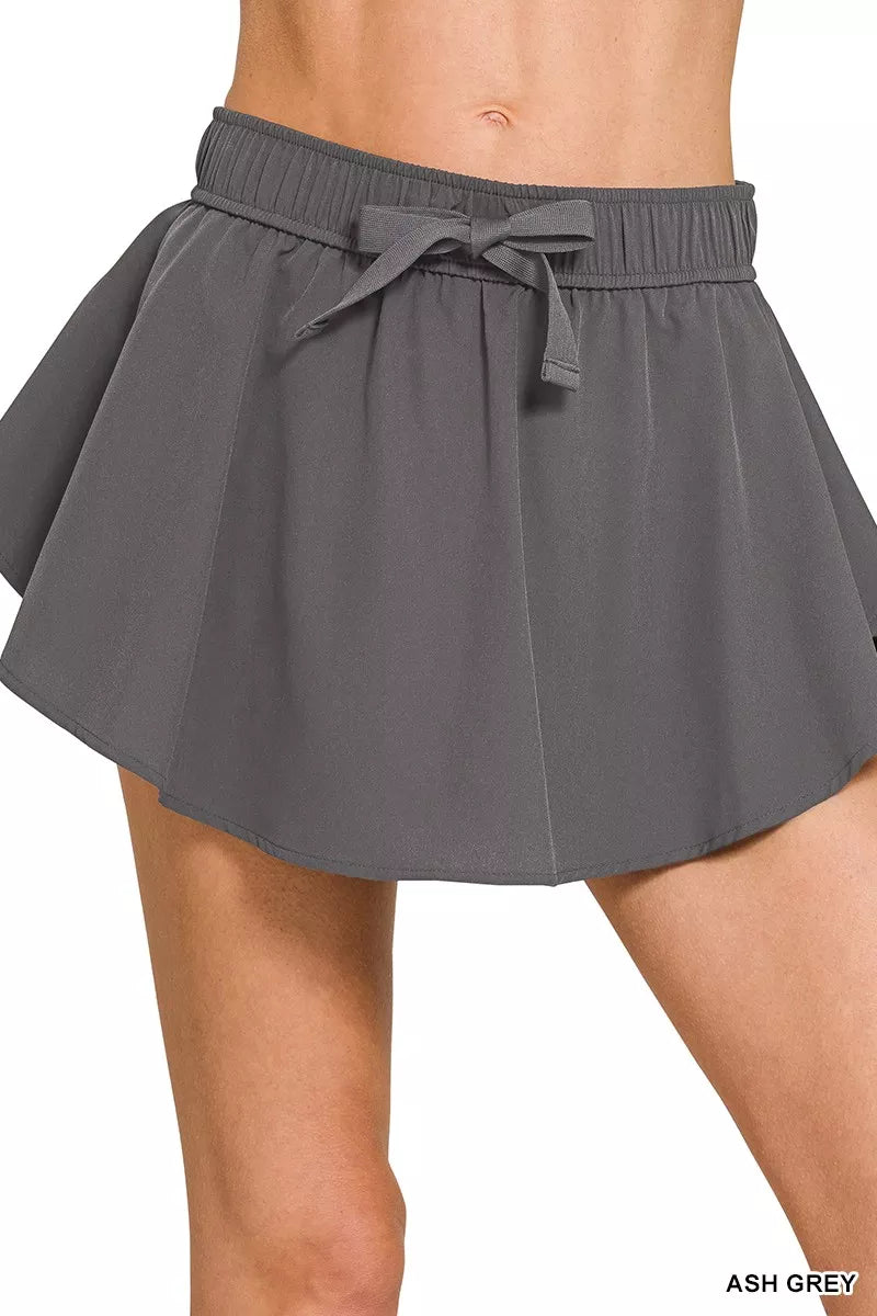 Ash grey woven active skort with elastic waistband and tie-front bow