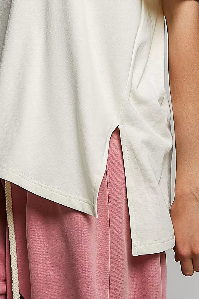 Cream cotton top close-up with side slit hem and cream fabric