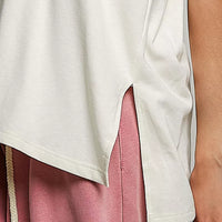 Cream cotton top close-up with side slit hem and cream fabric